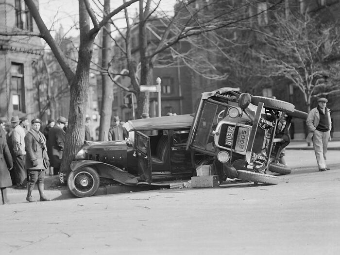 Vintage car accident scene with a crowd gathering, illustrating comically absurd facts about early 20th century events.