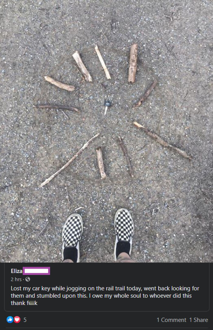 Car key found surrounded by sticks arranged in a sun pattern on the ground, showcasing faith in humanity restored.