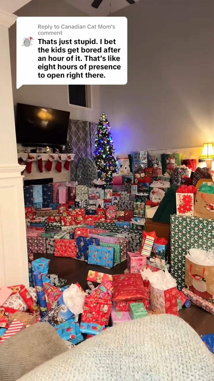 Living room filled with an insane amount of gifts for kids during the holidays, highlighting consumerism backlash.