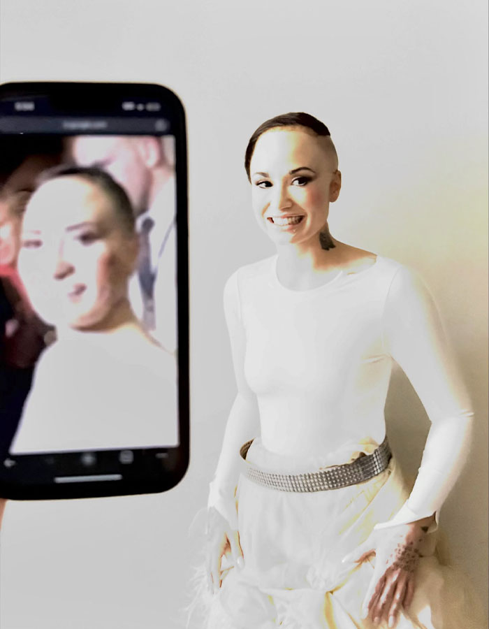 Celebrity with a unique Halloween costume smiling for a phone photo, showcasing creative Halloween costumes this year.