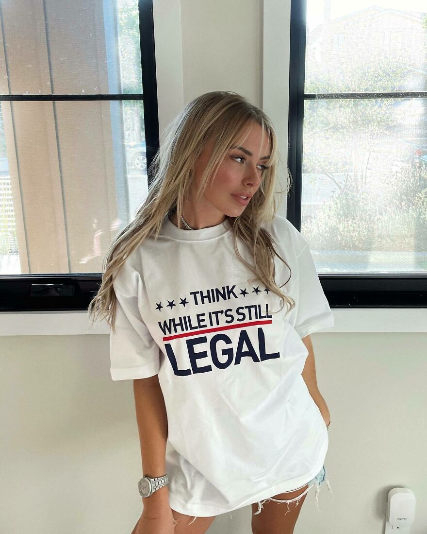 Corinna Kopf wearing a graphic tee indoors next to windows showcasing internet fame and net worth influence. Corinna Kopf wearing a graphic tee indoors next to windows showcasing internet fame and net worth influence.