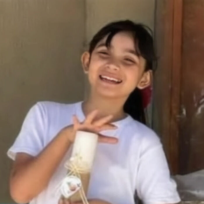 Smiling 9-year-old girl holding a candle, related to mother accused of giving her anti-anxiety medication.