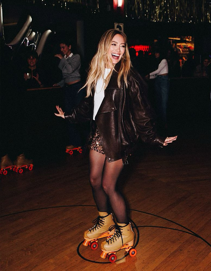 Hilary Duff roller skating indoors at a rink, sparking renewed outrage over her 2000s age-gap relationship.