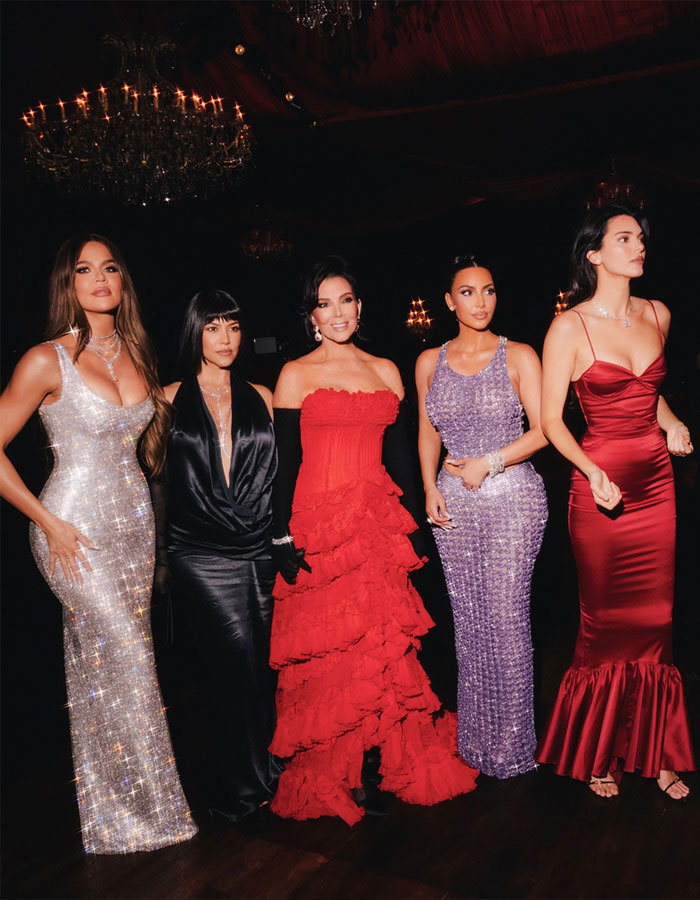 Kris Jenner family photo with women in elegant gowns sparking debate about the most annoying family member.