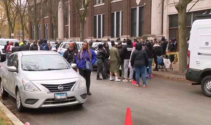 Crowd of young school kids gathered outside a building after pregnant woman is jumped by a mob and attacker is outed online.
