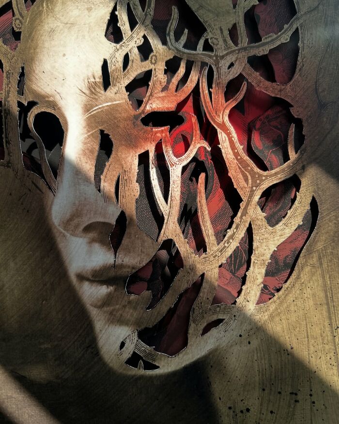 Surreal portrait collage with intricate cutouts revealing red patterns beneath, showcasing detailed and layered artistic design.