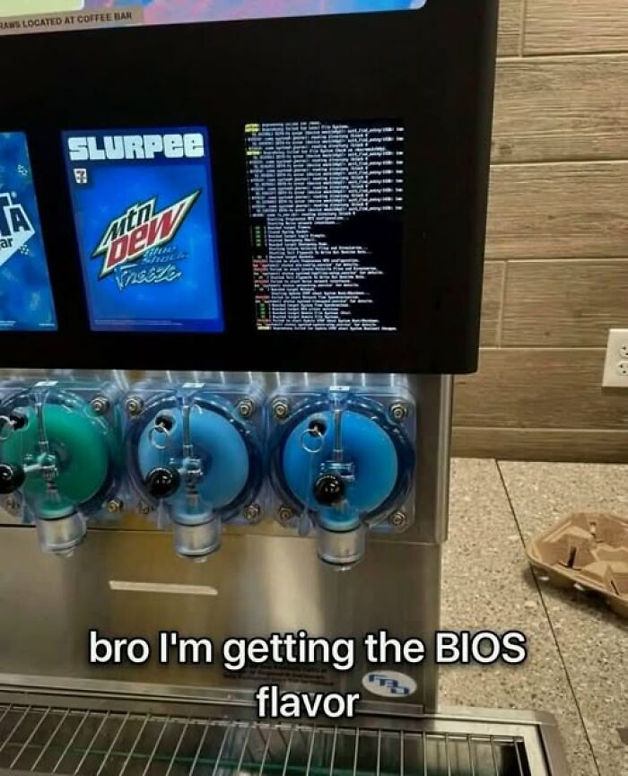 Slurpee machine dispensing Mountain Dew Baja Blast flavor with a BIOS screen displayed on the machine panel.