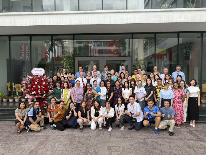 Group of people gathered outside a building, commemorating a father and son who lost their lives in a tragic zip-lining incident.