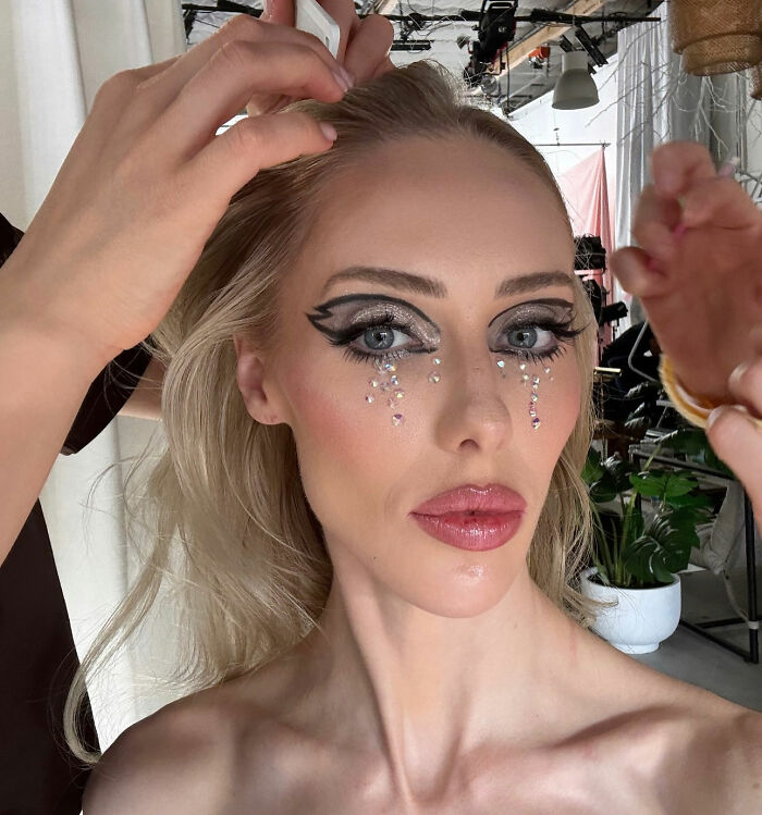 Singer with dramatic eye makeup having hair styled, representing singer who says she accidentally married Malaysia&rsquo;s ex-king.