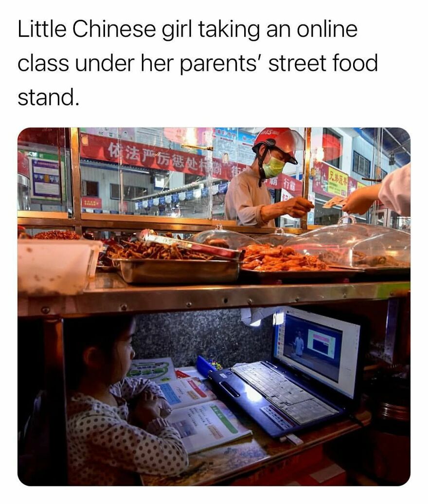 Young girl attending an online class under her parents' street food stand, highlighting wholesome daily life moments.
