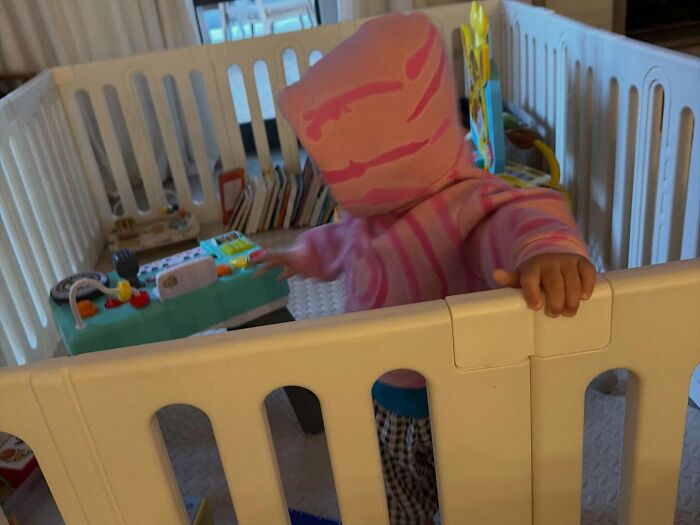 Toddler playing inside a white safety playpen with toys scattered around, capturing concern for Justin Bieber's child. Toddler playing inside a white safety playpen with toys scattered around, capturing concern for Justin Bieber's child.