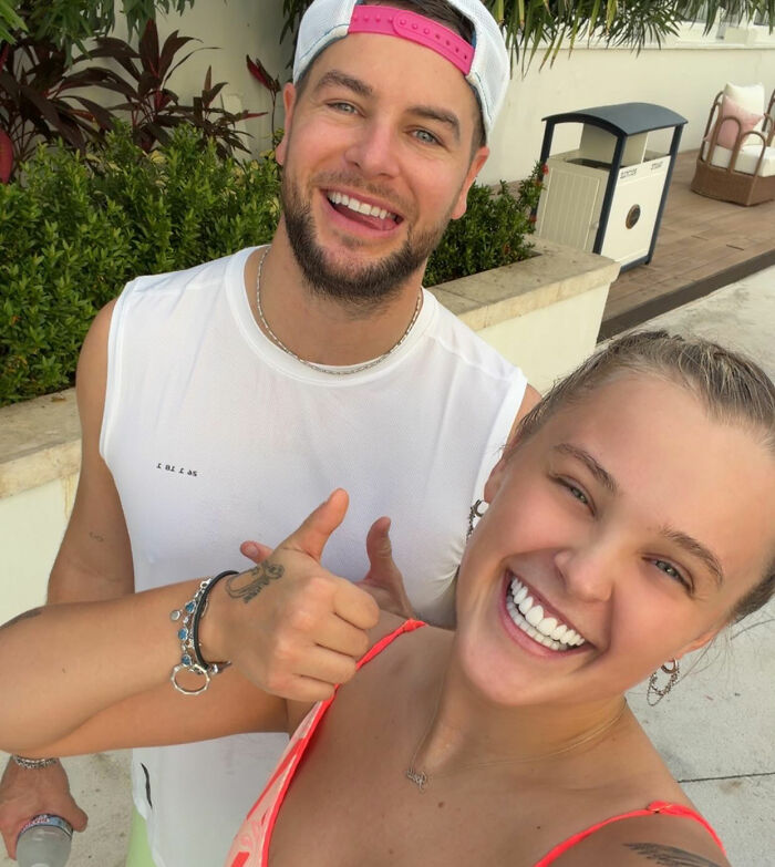 Chris Hughes smiling outdoors with a woman, fans stunned and confused by his reality TV show confession.