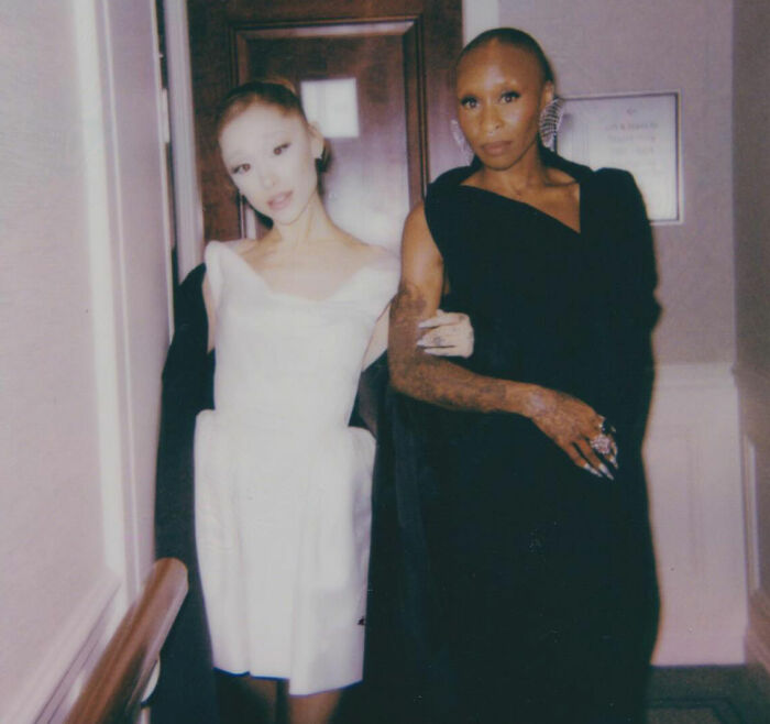 Cynthia Erivo and Ariana Grande posing together at an event, highlighting their new bizarre interaction.