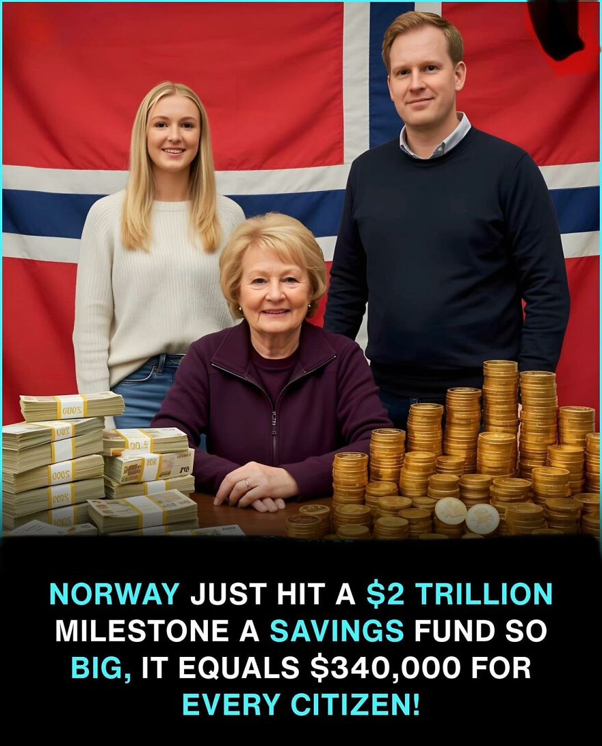 Three people standing behind a table with stacks of money and coins representing a big savings fund milestone.