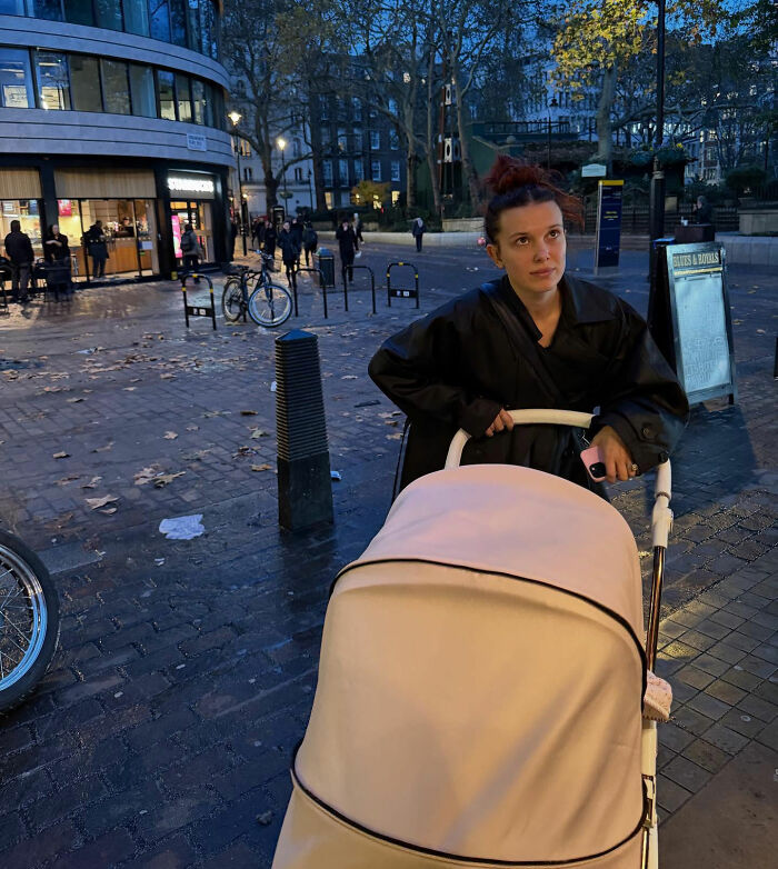 Millie Bobby Brown outdoors at dusk pushing a stroller, capturing attention amid Jake Bongiovi controversy. Millie Bobby Brown outdoors at dusk pushing a stroller, capturing attention amid Jake Bongiovi controversy.