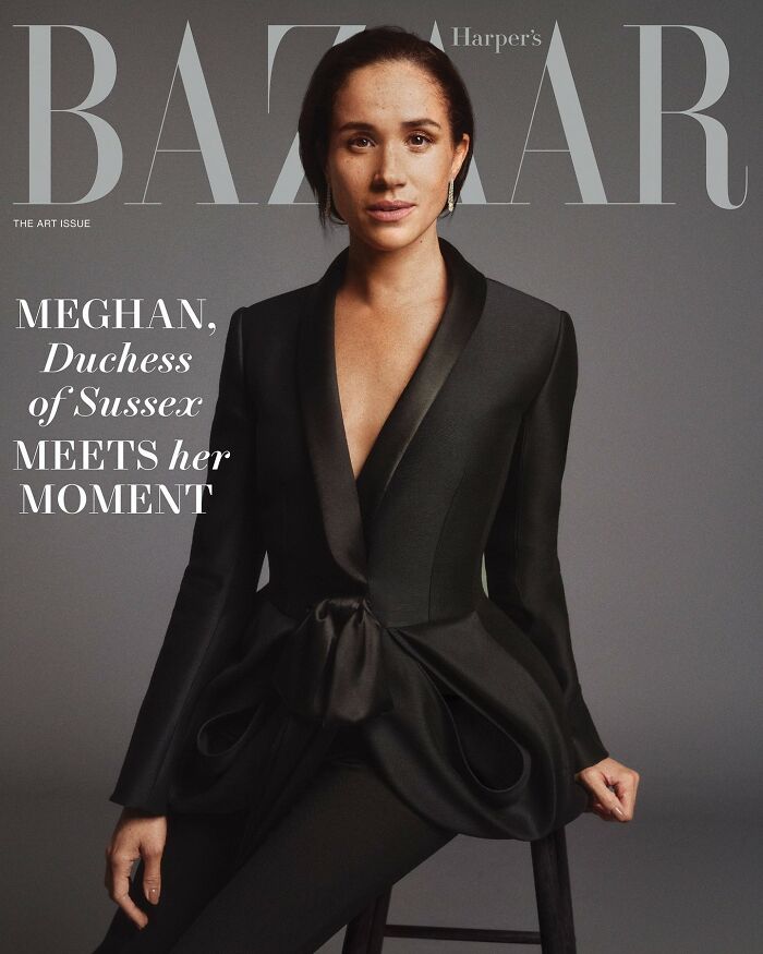 Meghan Markle posing makeup-free in a stylish black suit for a Harper's Bazaar cover photo shoot.