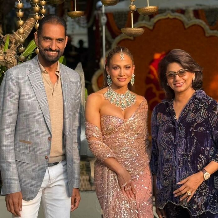 Jennifer Lopez posing in a glittering outfit during her risqué performance at a billionaire's wedding event. Jennifer Lopez posing in a glittering outfit during her risqué performance at a billionaire's wedding event.