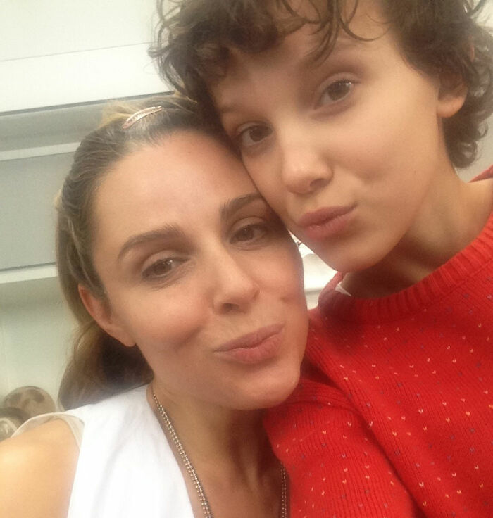 Stranger Things star Millie Bobby Brown with a woman, close-up selfie highlighting bullying issues faced by the actress.