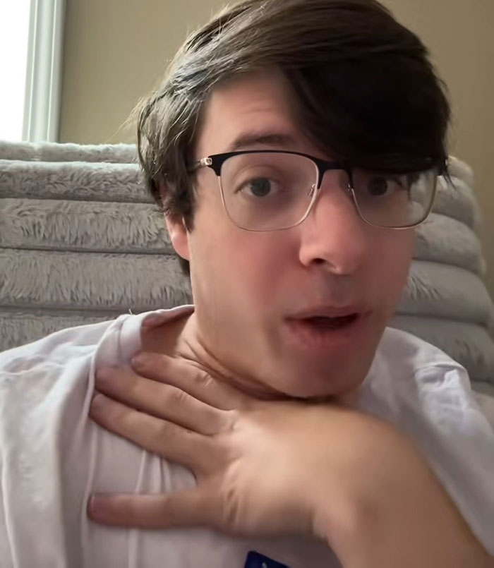 Young man wearing glasses and a white shirt discussing why modern movies look ugly with millennial gray tones in a video.