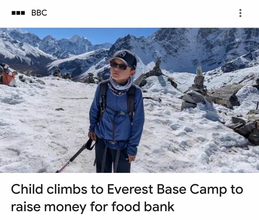 Child climbing snowy Everest Base Camp, showing wholesome act with unexpected deeper meaning in challenging environment.