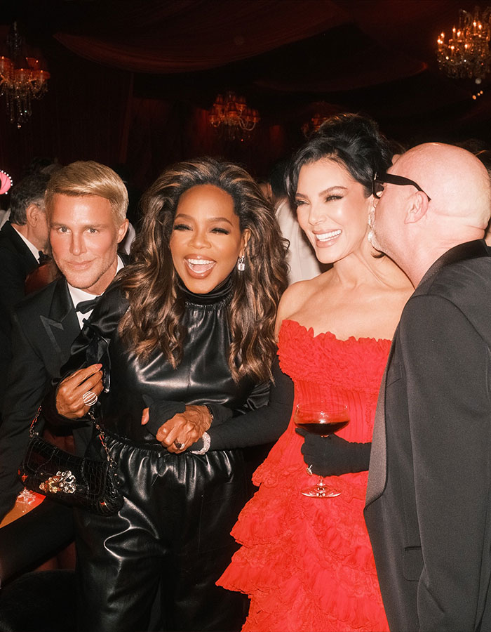 Guests at Kris Jenner's 70th birthday bash smiling and enjoying the glamorous party atmosphere in elegant attire.