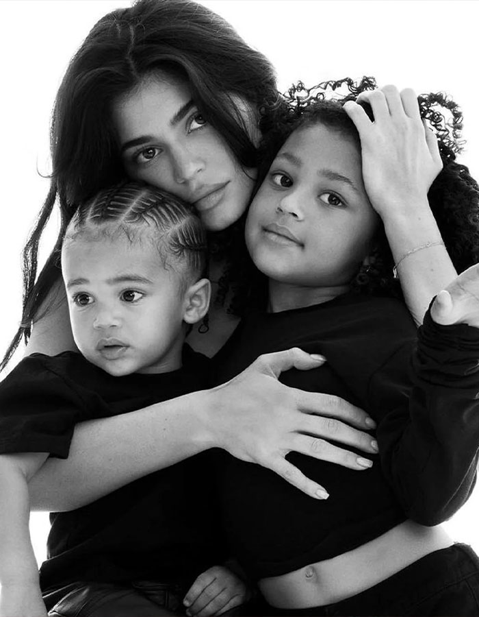 Woman embracing two children in a black and white photo, illustrating themes related to Timothée Chalamet kids backlash. Woman embracing two children in a black and white photo, illustrating themes related to Timothée Chalamet kids backlash.