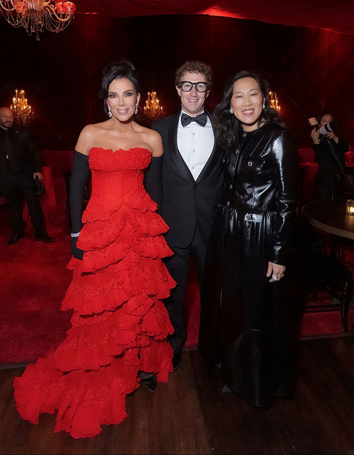 Guests at Kris Jenner's 70th birthday bash dressed elegantly in a red gown and formal black attire, stunning fans with the guest list.