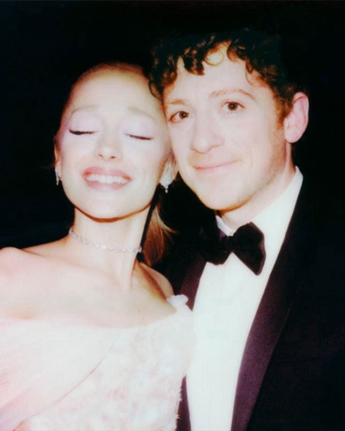 Ariana Grande and Jonathan Bailey dressed formally posing closely, highlighting home wrecking and intimate interaction buzz.