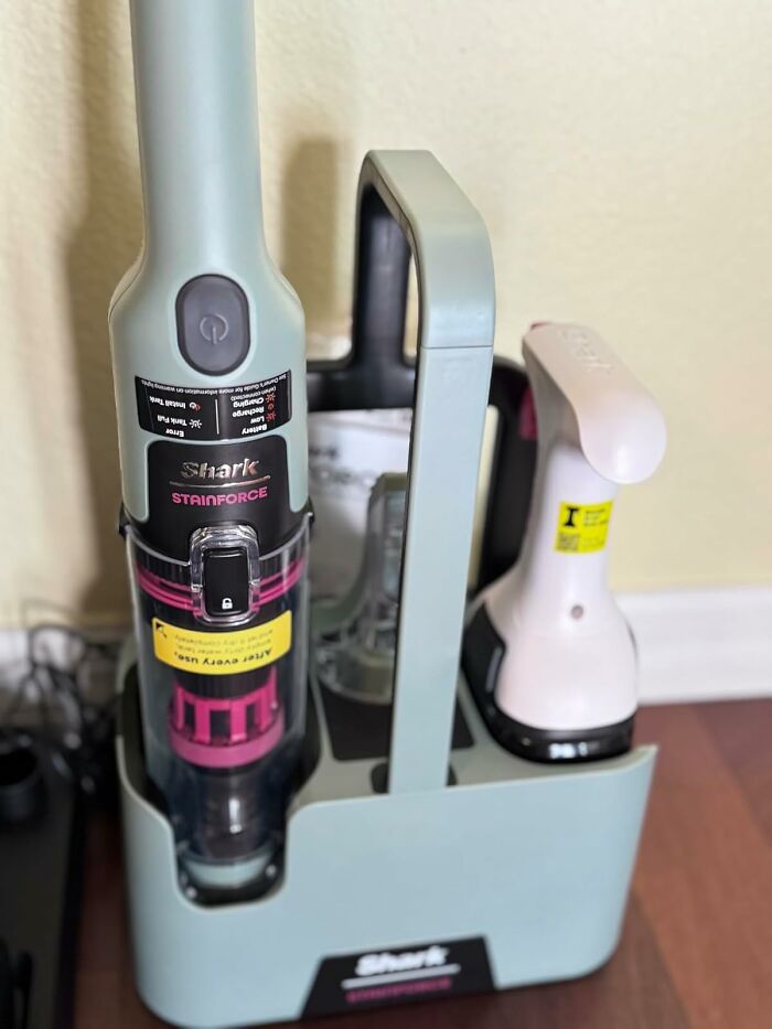 Shark Stainforce vacuum and cleaning tools in a charging station, highlighting popular Black Friday week splurges.
