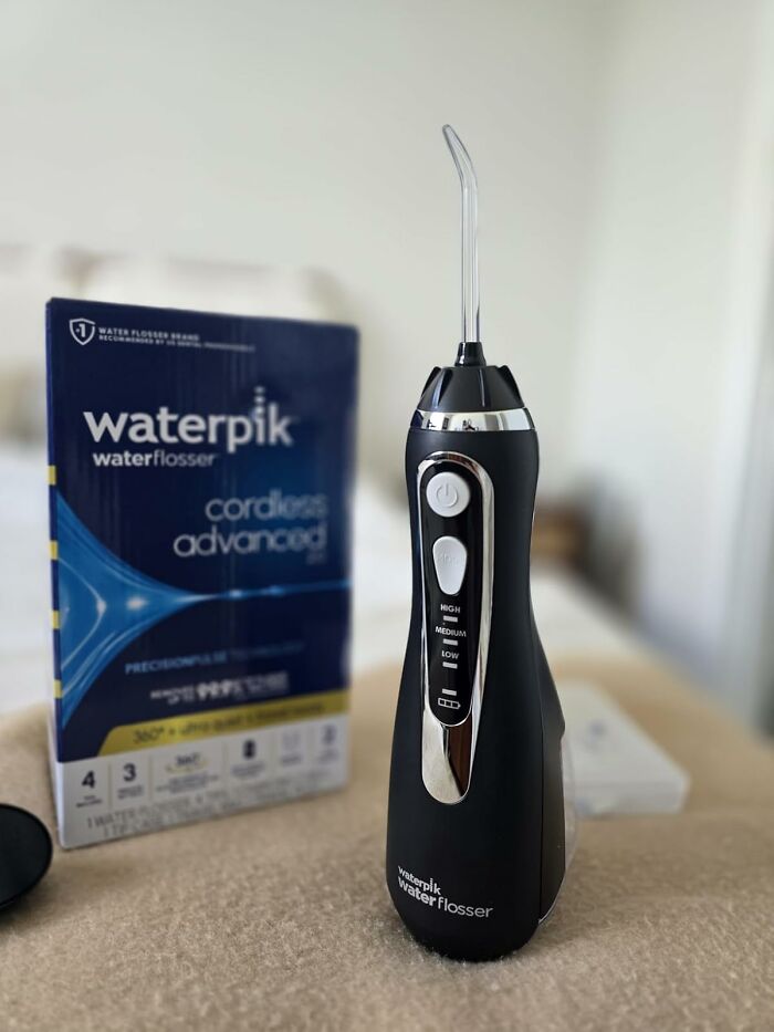 Black Friday deals on Waterpik cordless advanced water flosser shown with packaging in a bright room.