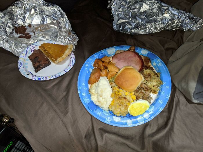Plate of homemade comfort food with ham, mashed potatoes, roll, and pie, showing faith in humanity restored through kind gestures.
