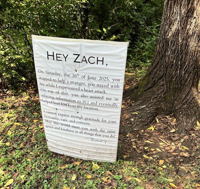 Sign expressing gratitude to a stranger for kindness and helping during a heart attack, restoring faith in humanity.