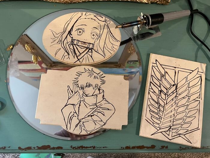 Woodburning art of anime characters and symbols, showcasing a creative hobby to keep your hands busy during hibernation season.