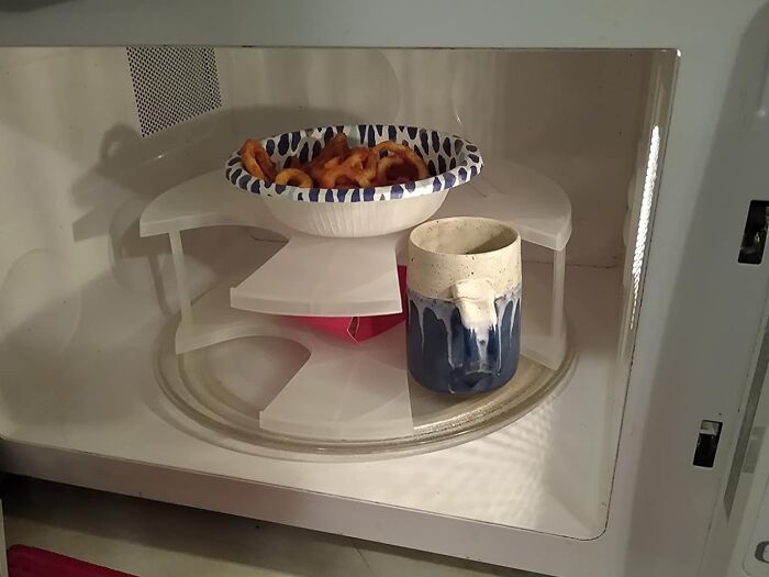 The Awkward Dance Of Reheating One Plate At A Time While Everyone Else's Food Gets Cold Is Officially Over Thanks To This Microwave Plate Stacker 