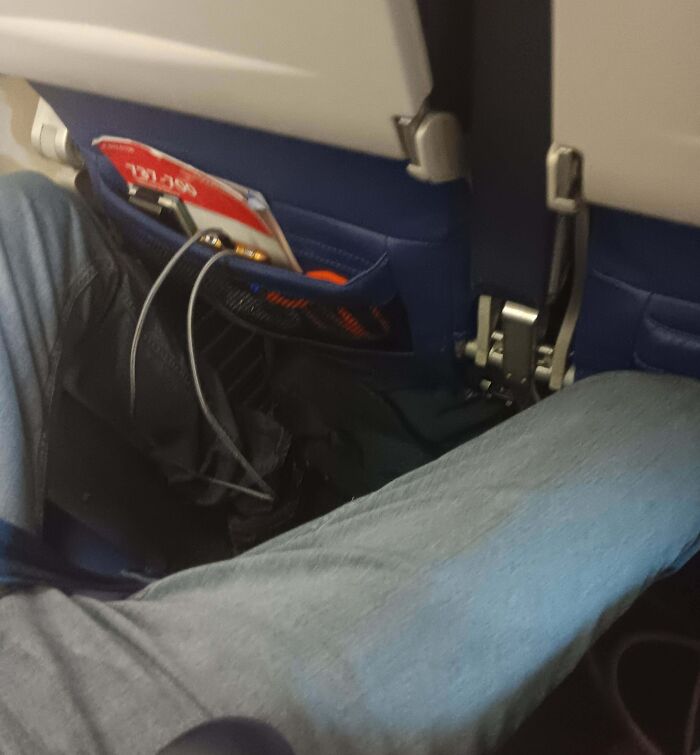 Passenger with zero common sense reclining seat excessively, blocking aisle and disturbing others on airplane flight.