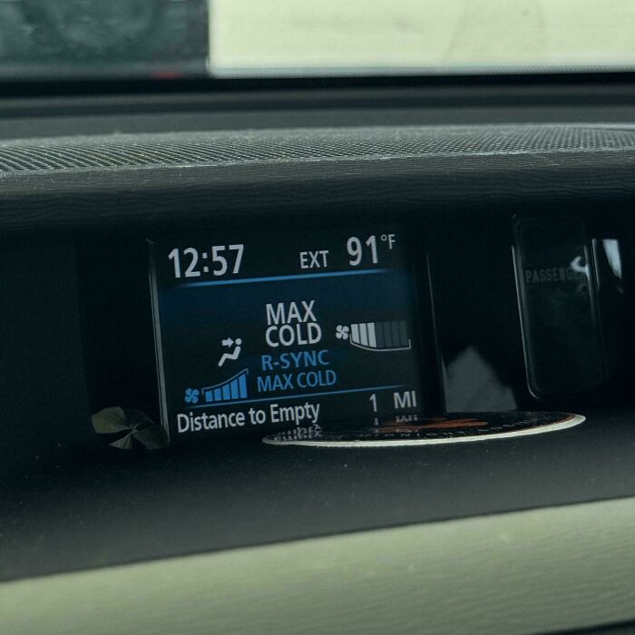 Car dashboard screen showing air conditioning set to max cold and outside temperature of 91 degrees Fahrenheit.