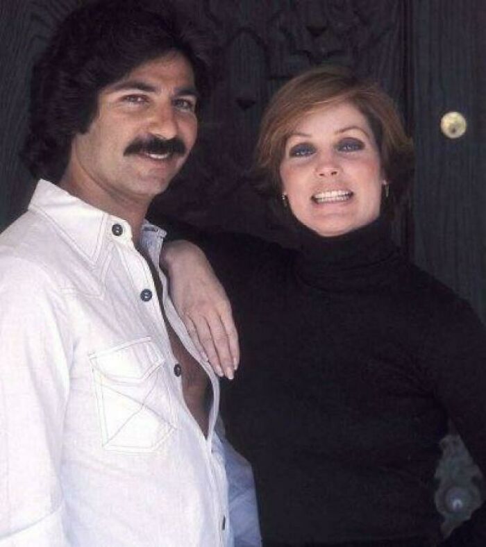 Man with mustache in white shirt and woman in black turtleneck posing together in a unique historical photo with deep backstory.