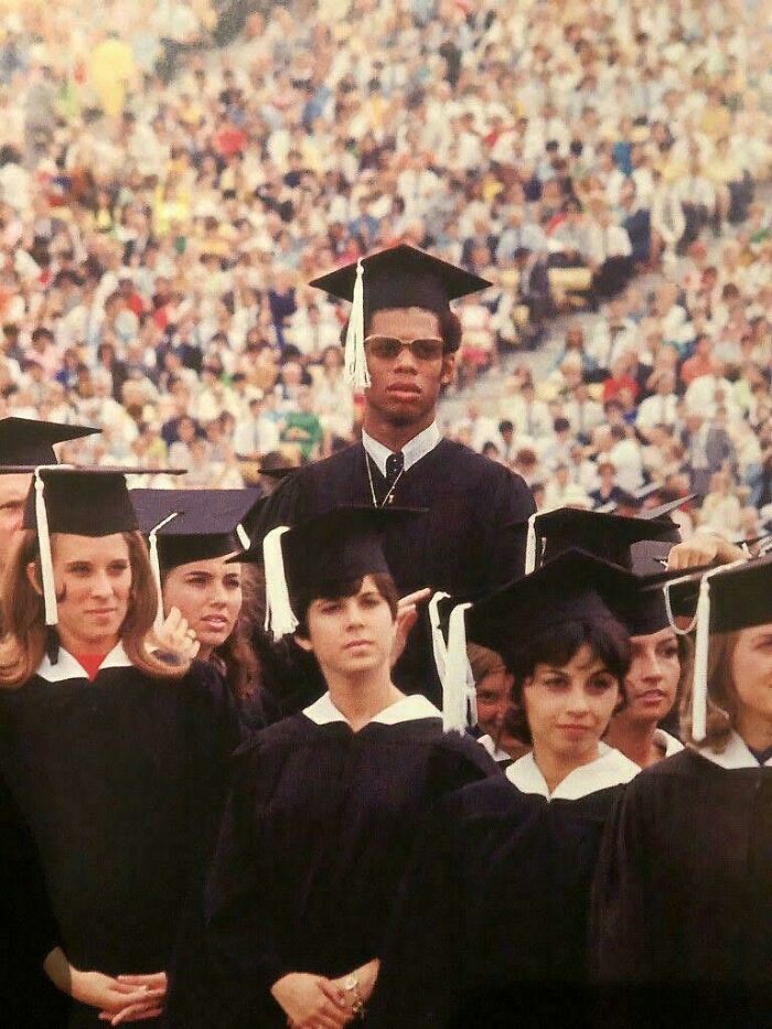Graduates in caps and gowns at a historical graduation ceremony captured in a unique historical photo with a deep backstory.