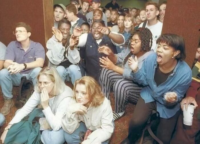 Group of diverse people reacting in surprise and excitement, captured in a unique historical photo with a deep backstory.
