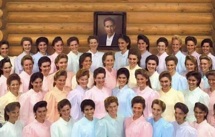 Group of women in pastel dresses posing inside a wooden building, a unique historical photo with a deep backstory.