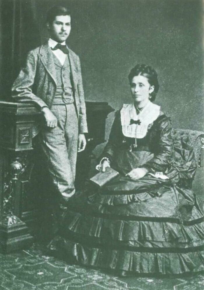 Vintage historical photo of a man and woman in formal attire from the 19th century with a deep backstory.