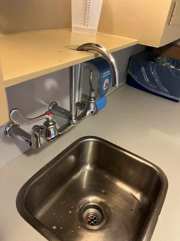 Sink faucet bent upwards through countertop, a funny example of people not even trying to fix or install properly.