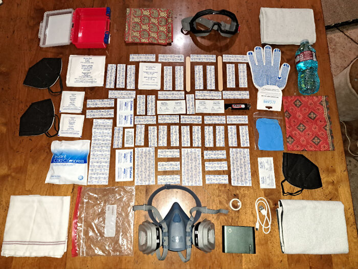 Neatly arranged first aid and safety supplies on a wooden surface showing satisfying order and organization.
