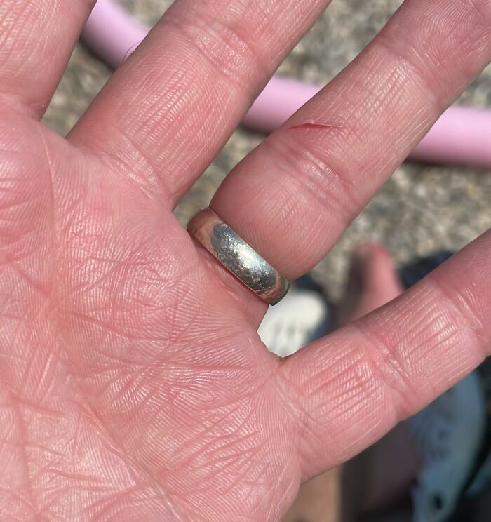 Close-up of a hand with a silver ring symbolizing faith in humanity restored through kind acts of strangers.