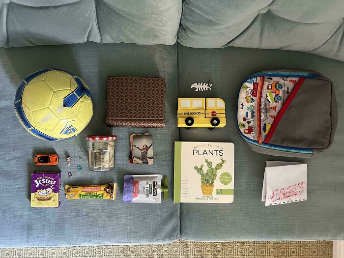 Neatly arranged everyday items including a soccer ball, book, toys, and snacks demonstrating visual order and knolled organization.