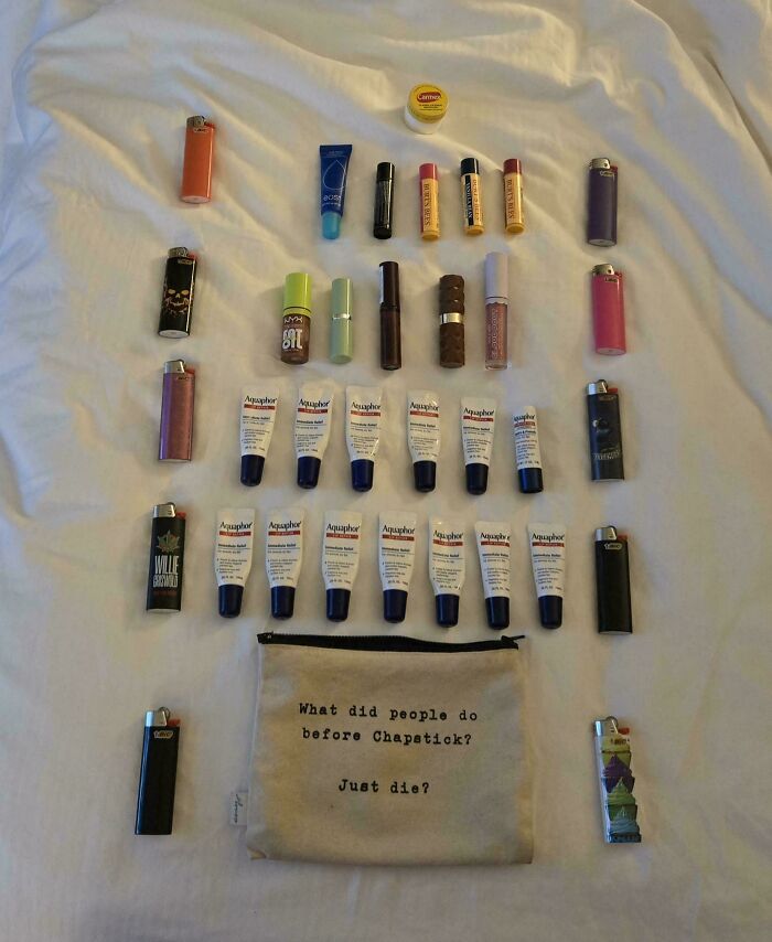 Neatly arranged lip balms, lighters, and a pouch on a white surface illustrating satisfying knolled organization.