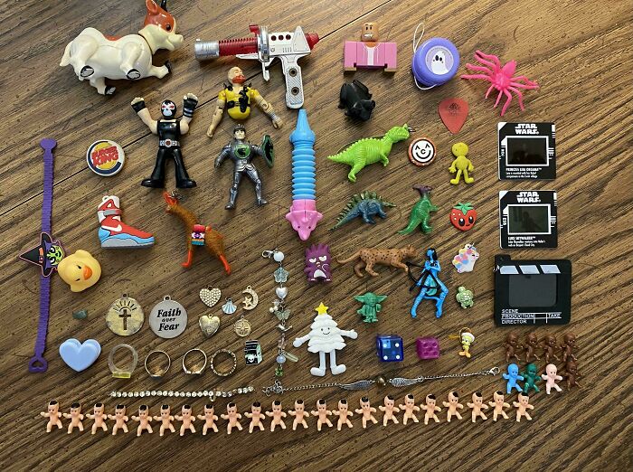 Various small toys and trinkets neatly arranged on a wooden surface, showcasing order and organization satisfaction.