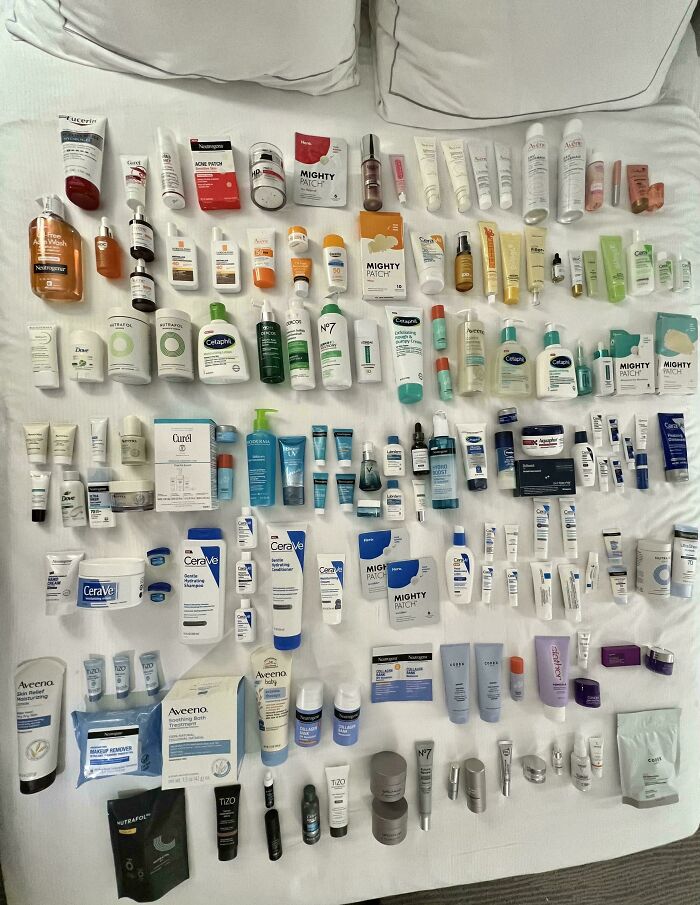 Neatly arranged skincare products on a bed, showcasing order and organization to satisfy need for order.