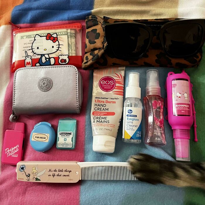 Organized personal items including hand cream, lens cleaner, and lip balm, showcasing satisfying knolled arrangement.