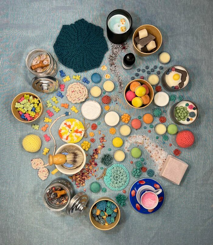 Colorful organized items arranged neatly on a blue surface, showcasing satisfying and soothing knolled order concepts.